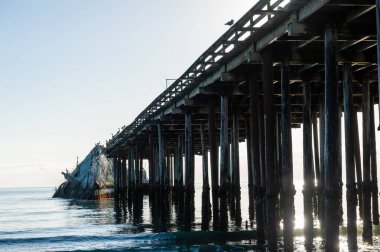 Exterior shot of the wooden support structure that carries the Sea Cliff Pier near Aptos, California.