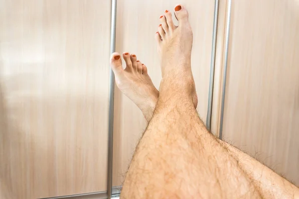 male hairy legs with red pedicure. gay concept
