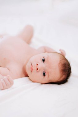 Stüdyoda beyaz ışığa karşı iki haftalık yeni doğan bebek