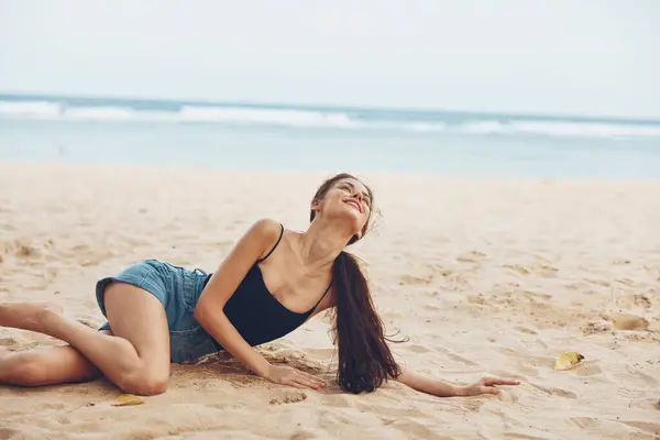 long woman ocean freedom person smile travel holiday sitting fashion sexy outdoor beach hair vacation nature female sand relax happy lifestyle sea