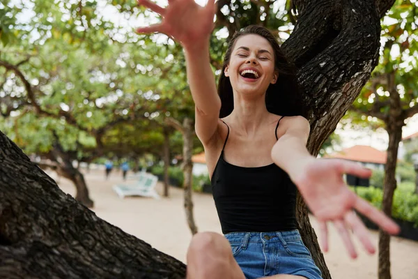 stock image woman girl outdoors sunny relaxation lifestyle alone freedom long palm hair nature sunset vacation beach hill sitting sky tree sea smiling relax