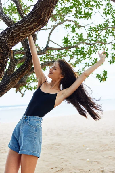 hanging woman hair summer tree beautiful hill vacation paradise nature sand lifestyle holiday sea relax long sitting ocean sky trunk happy smiling