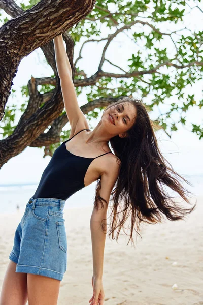 woman sand relax smiling looking vacation sky nature happy ocean sea tree hanging playing leisure person fitness relaxation lifestyle female paradise