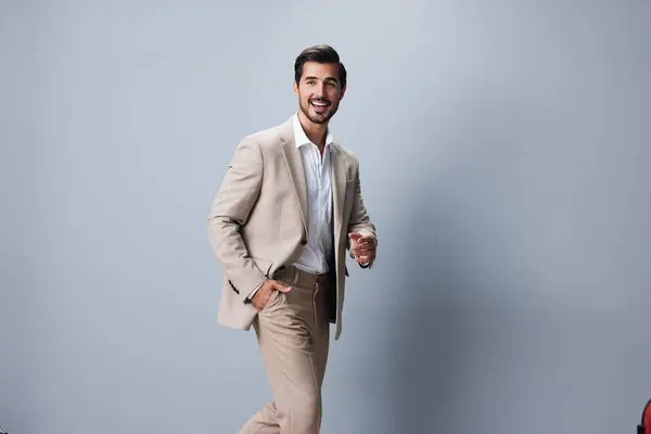 studio man businessman suit fashion attractive professional shirt handsome folded standing office crossed stylish beige happy business portrait copyspace successful smiling