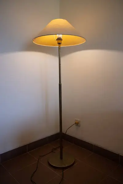 Interior with floor lamp and glow bulb in the dark at night, one lamp in the corner against a floor lamp wall. High quality photo