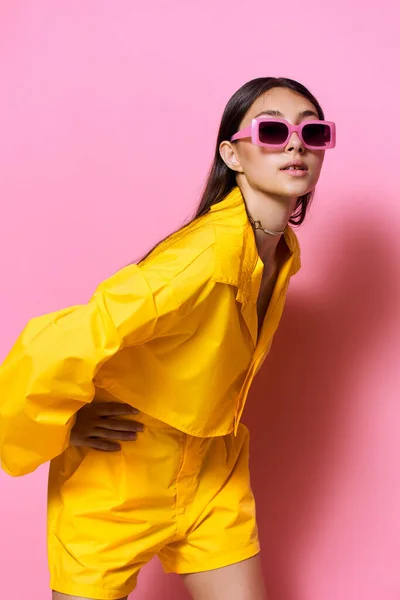 stock image female woman brunette glamour sunglasses fun attractive lifestyle model girl trendy young beauty beautiful style smile fashion yellow outfit stylish emotion