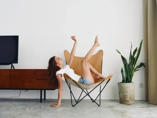 Woman Lying Leather Armchair Raised Arms Legs Cheerful Happiness Smile — Stock Photo, Image