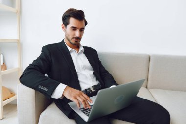 Modern insan profesyonel çekici dizüstü bilgisayarı bağlar. Oturan iş adamı koltuğu. Ofis beyaz iş yeri, kendine güvenen video işi.