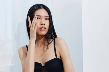 Asyalı siyah saçlı kız çekici kozmetik yüz güzel Koreli model çekici saç güzellik uzun zarif moda portre güzellik salonu beyaz şirinlik