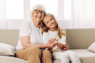 Son sınıf öğrencisi kadın torun ev büyükannesi torun bakıcısı yaşlı kız sevgili anne mutlu kanepe eski nesil kucak