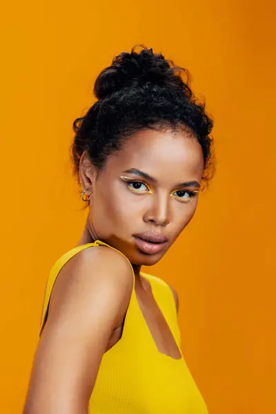 Beautiful woman cosmetology model pink copy african skin yellow face portrait style make-up studio eye beauty colourful ethnic cosmetic smile space creative fashion black