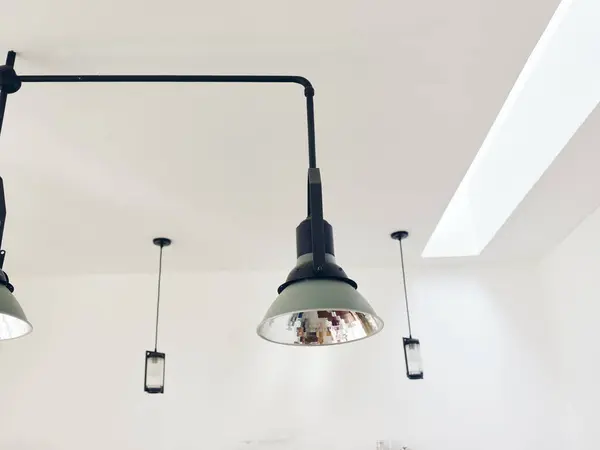 Stylish retro chandelier on white ceiling in a vintage interior, modern design. High quality photo