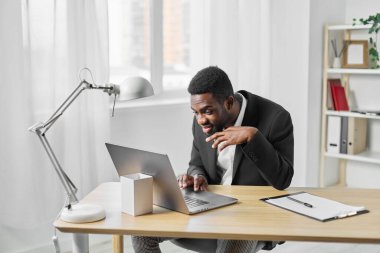 Amerikalı bir adam bilgisayarına laptop eğitimi diyor sohbet masası modern ofis internetteki serbest çalışan Afrikalı iş adamı teknolojisi gülümseyen bilgisayar