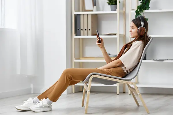 video lifestyle chair sound music phone relax girl smile caucasian teenage portrait sitting earphones happy studio white meditation young player
