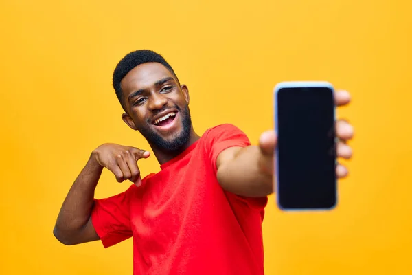 man phone device black adult happy trendy afro internet african young background technology male advertisement cellphone online mobile cyberspace portrait typing yellow