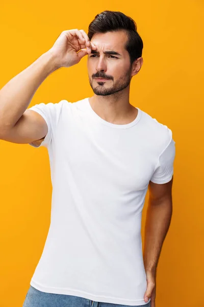 Man t-shirt white model lifestyle casual view jeans mockup studio portrait yellow cheerful front clothing clothes smile space copy template design casual shirt background isolated blank