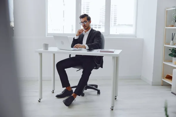 Man head stressed notebook working desk thinking angry table white workplace handsome tired frustration manager looking laptop stress adult portrait glasses sitting business office