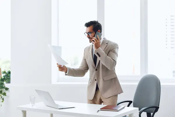 Wireless man call talk professional job call phone conversation winner businessman video laptop worker computer communication desk technology office adult smartphone glasses corporate smile