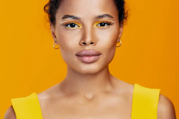 Woman cosmetic smile face make-up black model beauty creative style colourful cosmetology skin fashion portrait studio yellow beautiful african