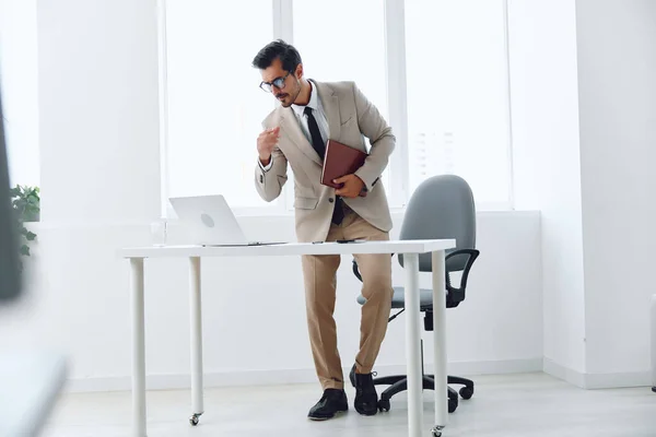 Man suit successful businessman background technology executive internet happy business males job gesturing portrait sitting laptop office excited scream winner