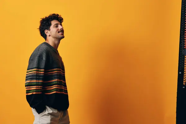 Man sweater person natural background orange adult winter happy fashion posing serious looking isolated emotion smile casual portrait yellow student hispanic trendy