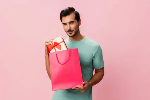 Present man gift store lifestyle portrait pink fashion shopper bag shop background isolated discount surprise client women day package holiday happy sale purchase buy