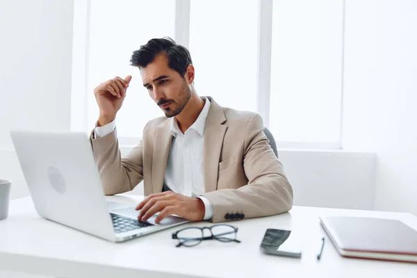 Confused man desk laptop beard technology handsome employee tired glasses head hands indoors business office thinking businessman casual sad working sitting worried