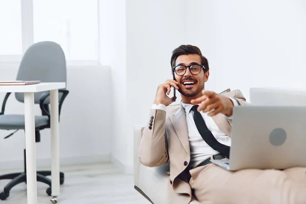 Smile man video laptop working portrait people glasses phone winner adult sofa office happy young businessman occupation talk call communication caucasian telephone computer internet