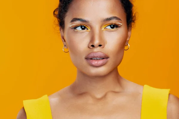 Woman black cosmetic african face skin cosmetology colourful creative model make-up style beautiful yellow beauty smile portrait fashion space studio copy