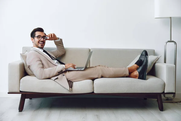 Couch man online business networking sitting hunk home communication attractive caucasian smiling apartment room guy sofa laptop relaxed call video white