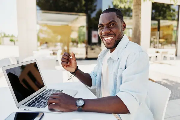 Man young happy professional wireless businessman lifestyle computer person working business sitting black technology looking laptop smiling african male adult casual internet modern handsome