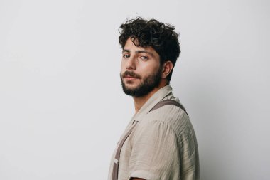 Çekici bir arka plan modeli. Keyifsiz, havalı, beyaz, yetişkin bir yüz. Kafkasyalı, soyutlanmış, sakallı, yakışıklı bir adam.