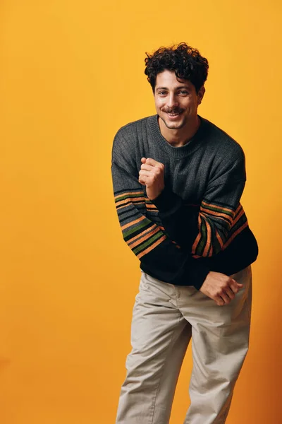 Man attire expression confident student head happy winter adult casual portrait orange background standing handsome isolated smile sweater natural fashion serious trendy