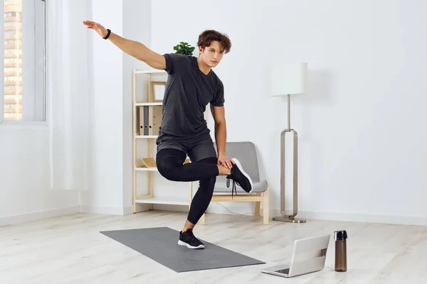 man lifestyle healthy yoga room health room house exercise living activity training sport young fitness home person strength body indoor abs laptop