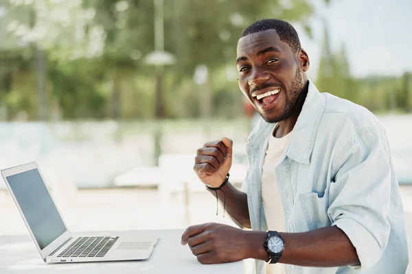 Smile man job person young businessman business black technology laptop online guy happy computer modern lifestyle sitting male looking office adult african working