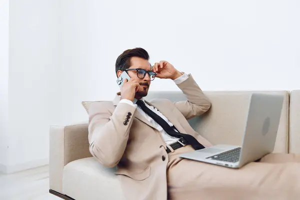 Call man successful video talk call worker businessman laptop glasses smile communication technology suit office winner couch young internet sofa phone computer job