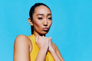 Kadın gülümsemesi gündelik stüdyo modası Asyalı şaşırmış model beyaz portre yaşam tarzı mavi güzel sarı ifade şirin moda güzelliğiyle karşılaşıyor