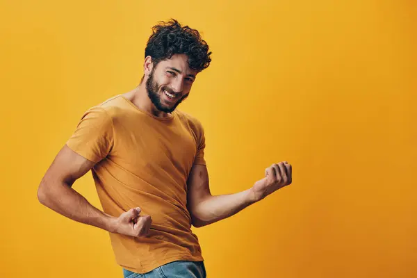 Man guy white person handsome model gesture copy yellow caucasian background emotion portrait adult studio joy cheerful expression space happy shirt face young black positive