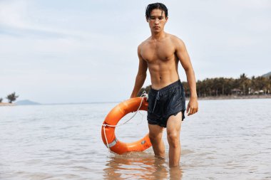 Asyalı cankurtaranları uyarın kumlu sahilde neşeli yüzücüleri gözetlesinler, canlı mavi okyanusta güvenlik ve kurtarma sağlansın.