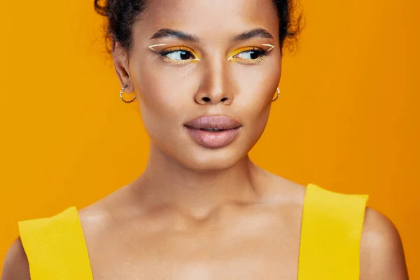 Eye woman face model make-up black yellow colourful smile pink cosmetology creative happy fashion african studio cosmetic style beauty beautiful copy ethnic space portrait skin
