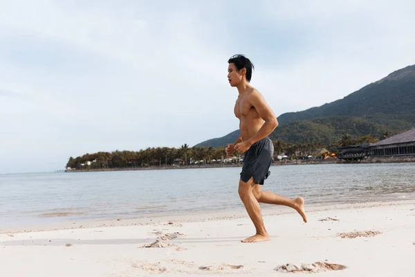 Athletic Asian Man Embracing Freedom Wellness While Running Beach Sunset — Stock Photo, Image