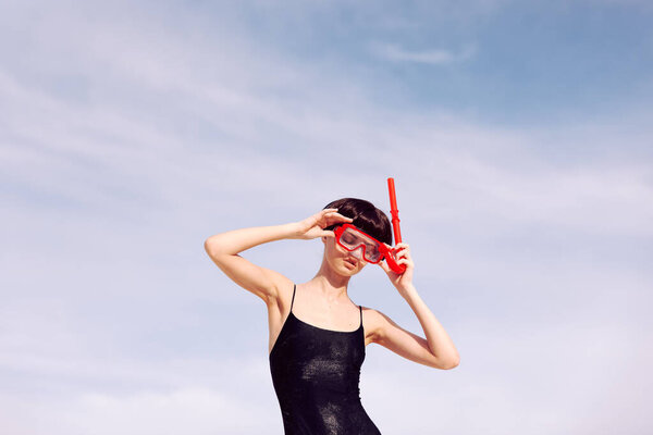Smiling Woman Snorkeling in Red Fashion Swimsuit: Portrait of Joyful Vacation Lifestyle.