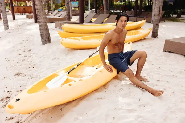 セリーンシーケープ トロピカルビーチでハッピーなアジア人男性カヤック 健康でアクティブな夏休みを楽しむ — ストック写真