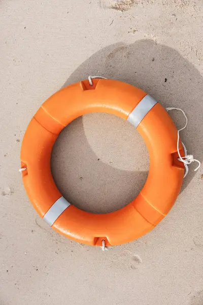 Rescue in the Sky: Lifeguard Saves Lifebuoy on Sandy Beach as Ocean Waves Crash