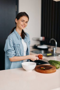 Mutfak Güzeli: Beyaz Yemek Masası 'nda Sebzeler ve Bıçakla Taze Salata Hazırlayan, Sağlık ve Mutluluk İçin Işıldayan Genç Kafkas Bir Kadın.