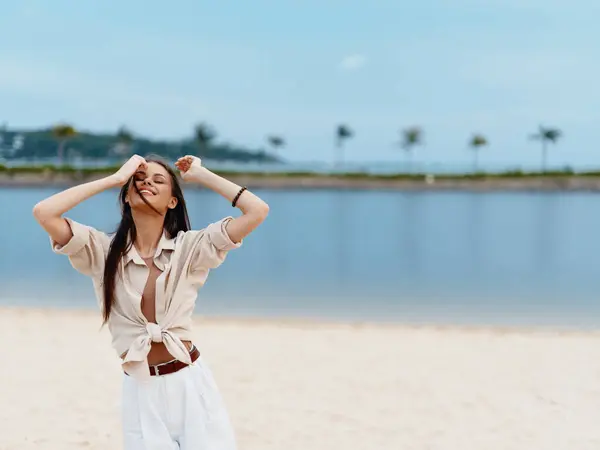 Summer Serenity: A Blissful Vacation on the Tropical Beach with a Happy Young Asian Woman Enjoying the White Sand, Clear Blue Ocean, and Sunny Sky