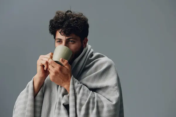 Young man tea beverage style morning handsome guy portrait caucasian person beard lifestyle mug adult casual drinking alone face home background attractive hair expression