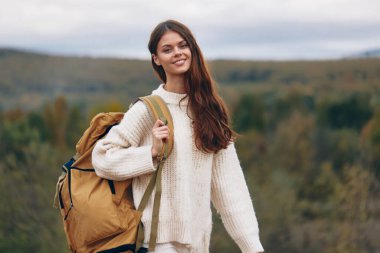 Dağ Macerası: Sırt çantasıyla Uçuruma tırmanan Gülümseyen Kadın, Doğanın ve Özgürlüğün tadını Çıkartıyor