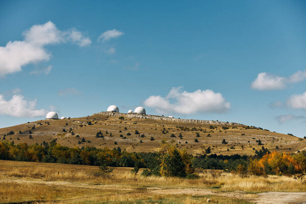 Three powerful telescopes capturing the beauty of the cosmos from a remote hilltop observatory on a clear day