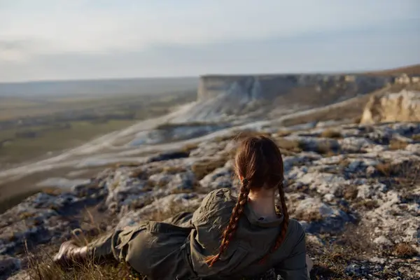 stock image Woman enjoying the majestic view of valley and mountains during a peaceful travel moment